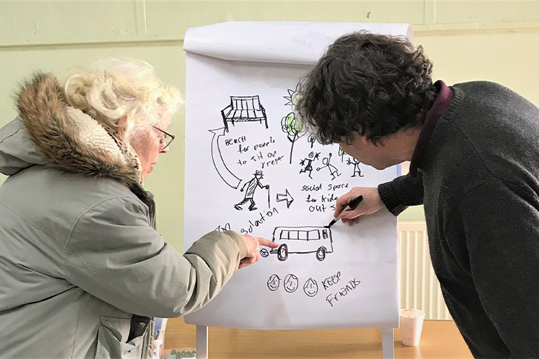 Graphic facilitator Tom Cross drawing and mapping out people’s ideas on the positive changes that could be made.