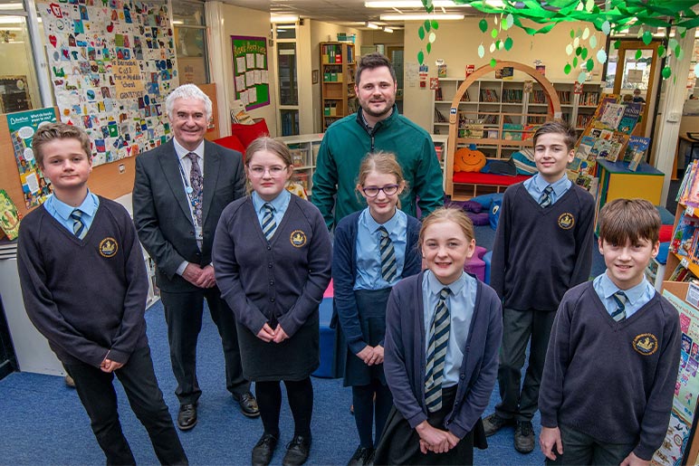 Children, construction manager and head teacher in the new library at St Barnabas school