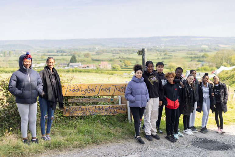 Hackney Youth Club lined up beside the Paddington Farm sign