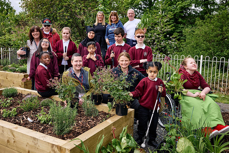 A group picture of staff and students from Priestly Smith Specialist School