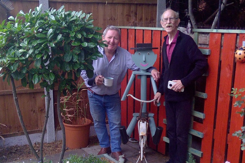 Two residents stood next to their garden feature