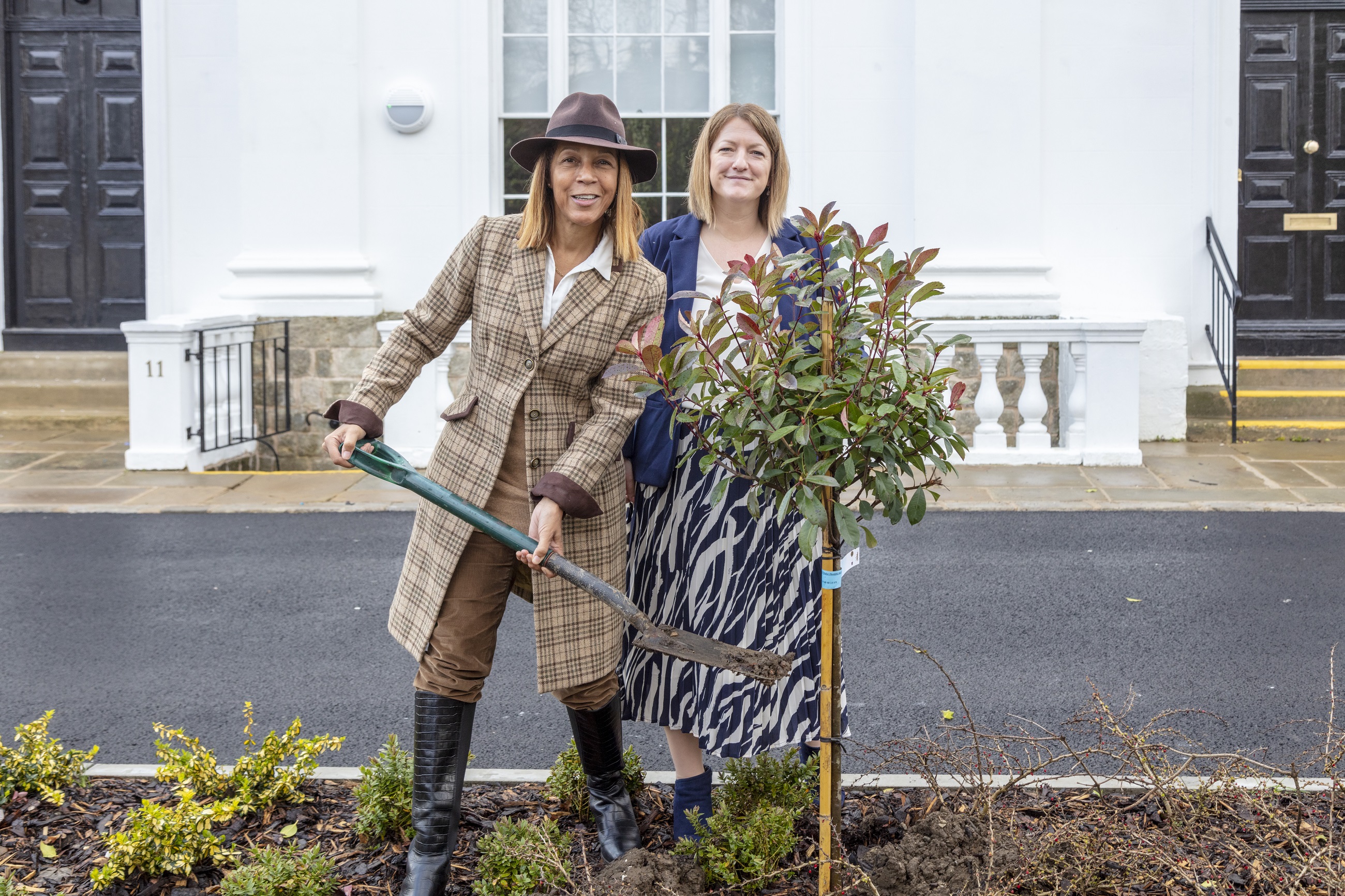 Helen Grant MP and Lizzie Hieron planting a small tree