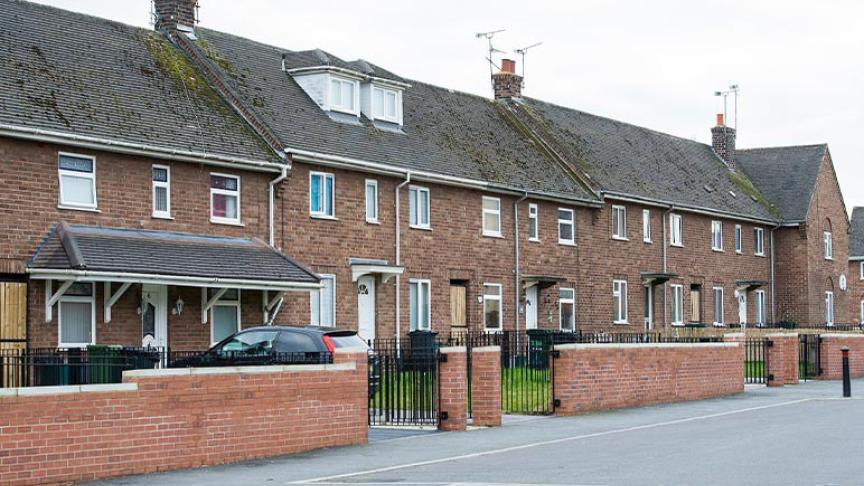 Terrace street of worn brick built properties