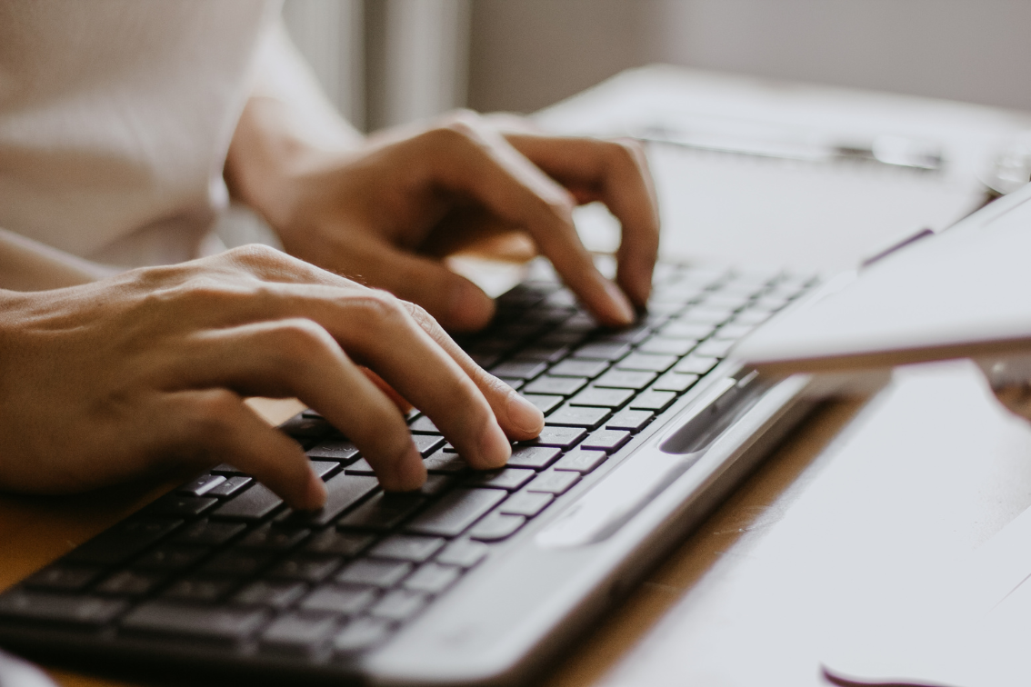 A close up of someone typing on a keyboard