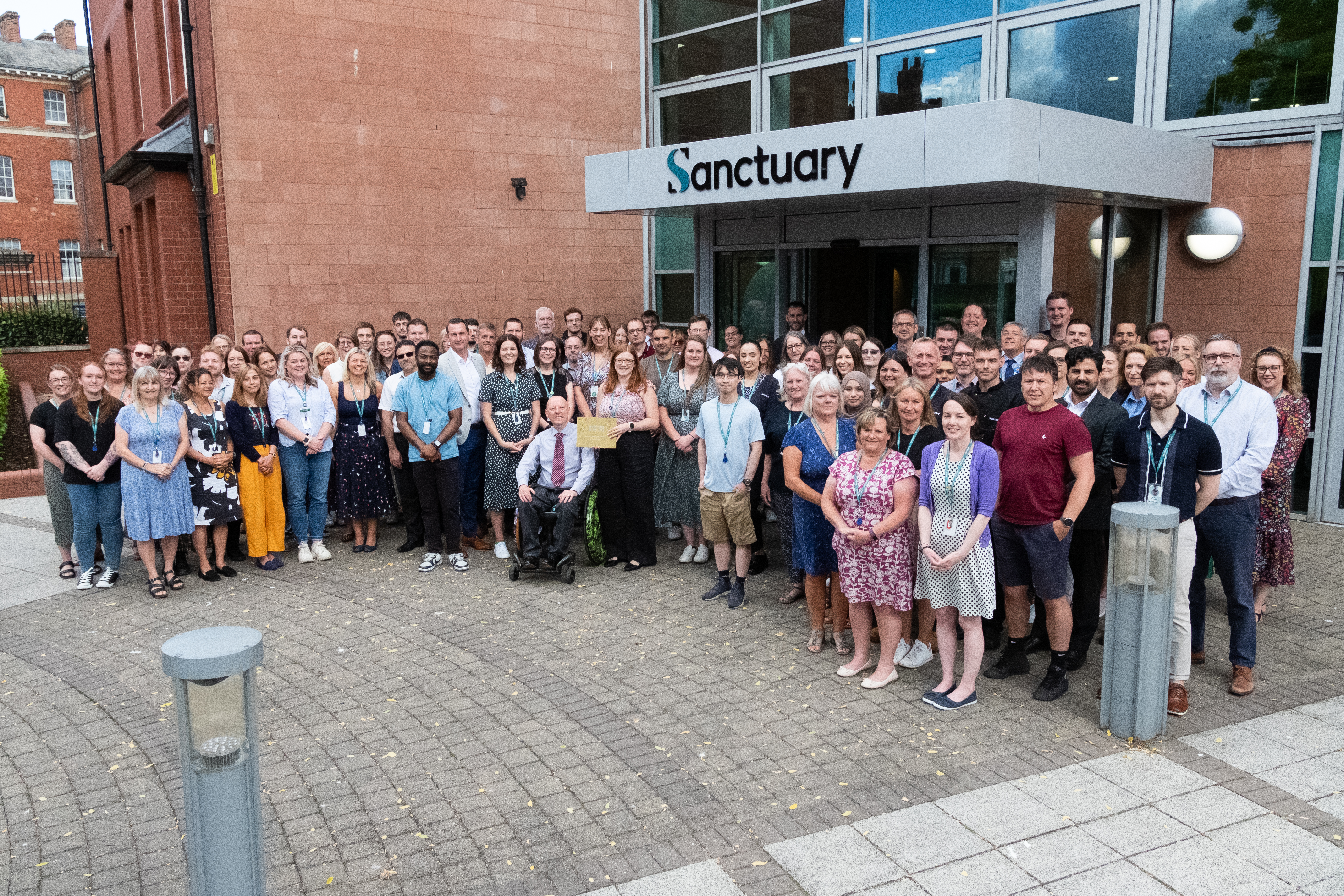 A large group of Sanctuary employees stood outside the head office in Worcester