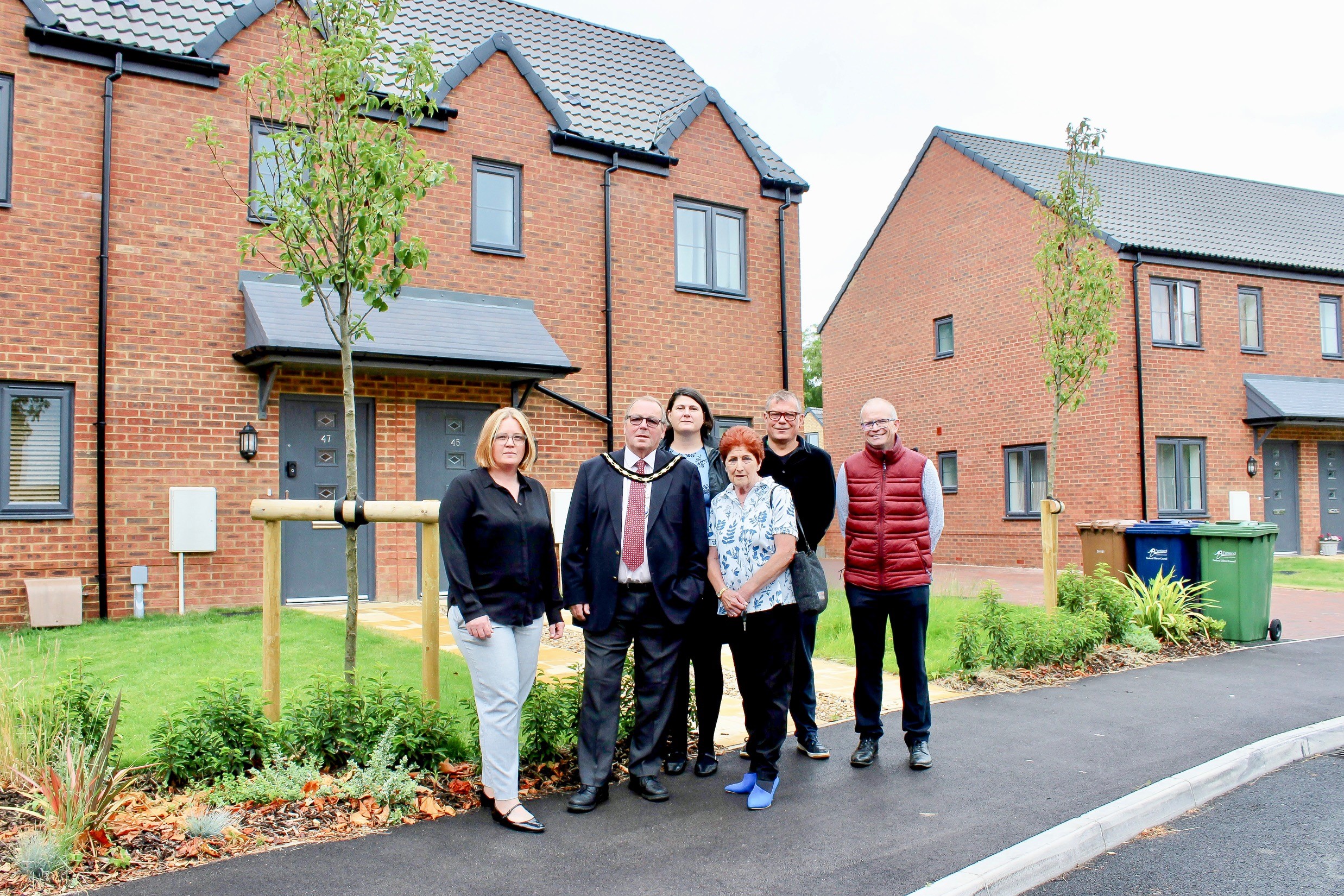 Sanctuary staff members and local councillors stood outside of affordable homes in March