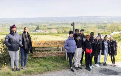 Hackney Youth Club lined up beside the Paddington Farm sign