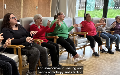 Sanctuary residents sat in a hall singing in the choir