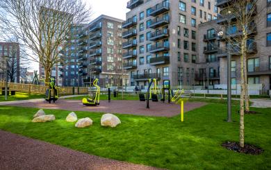 High rise buildings with an outdoor gym park in the forefront