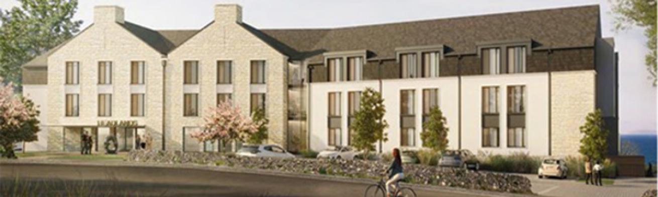 Computer generated image of the proposed exterior of Sanctuary's Carbis Bay care home. A cream brick building with a grey roof with a small car park and a stone wall in front.