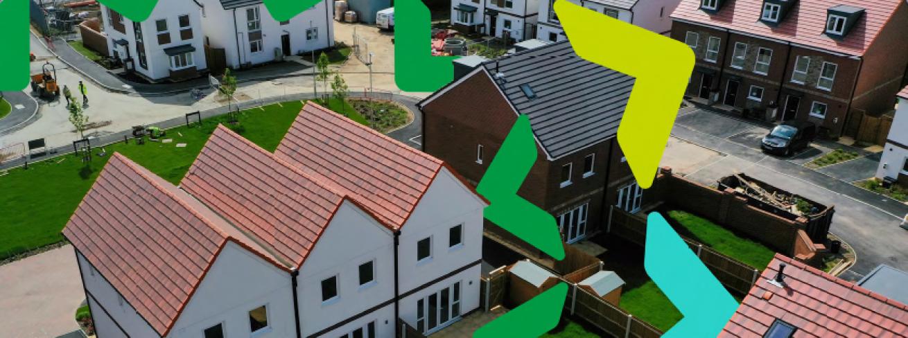 Aerial photograph of a housing development with terraced, semi-detached and detached homes with gardens separated by wooden fences