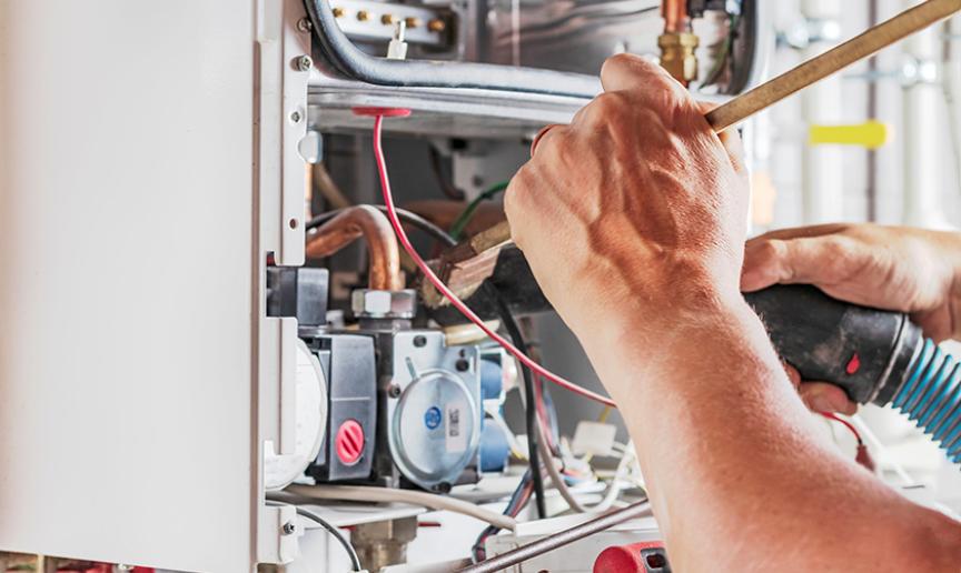 Person servicing a gas boiler