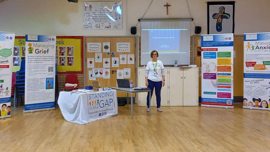 Standing in the Gap representative giving a presentation in a school hall