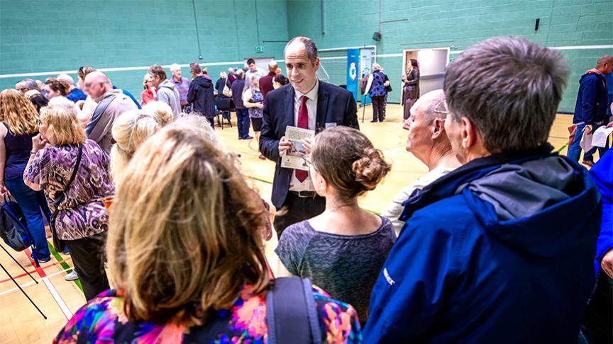 Members of the public gathering in an indoor hall to hear about Sanctuary's Laindon development plan