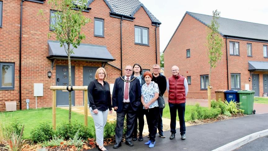 Sanctuary staff members and local councillors stood outside of affordable homes in March