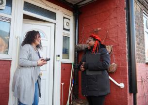 Sanctuary staff speaking to a resident outside their house