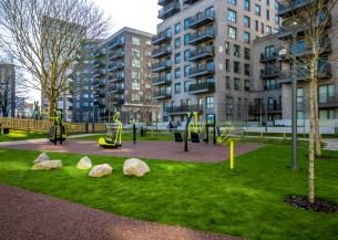 High rise buildings with an outdoor gym park in the forefront